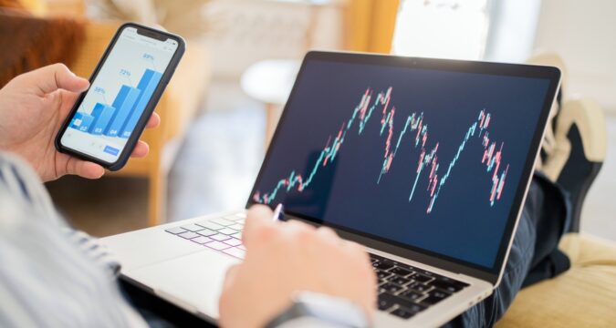 StockExchangeOnlineTraderStatisticsLaptopScreenWorkplaceInThe | Online Trading Secrets Cw-management.co Review, CW Management – Is CWManagement Scam or a Recommended Trading Platform?